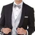 A man in a tuxedo is posing for a photo.