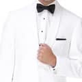 A man is posing in a white tuxedo available for suit rental.
