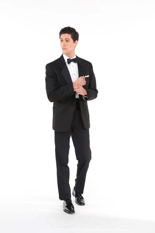 A man in an After Six Black tuxedo, available for suit rental or tuxedo rental, posing.