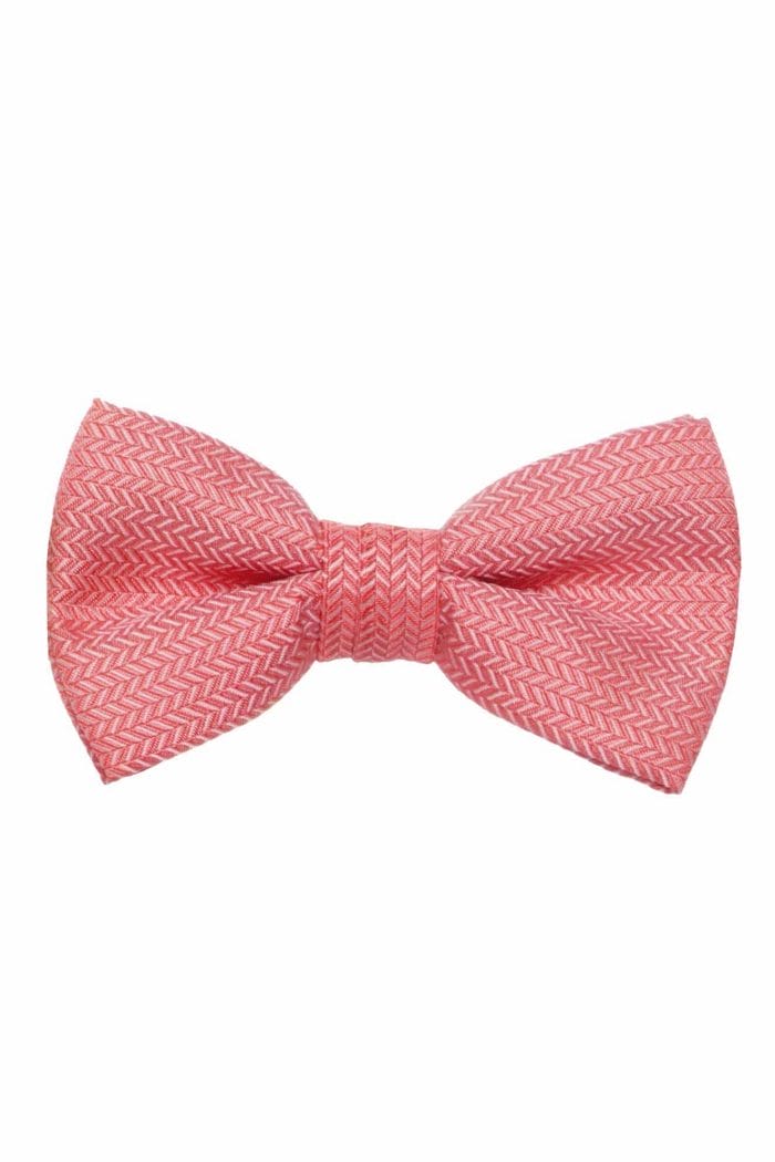 A pink bow tie on a white background, perfect for tuxedo rental.