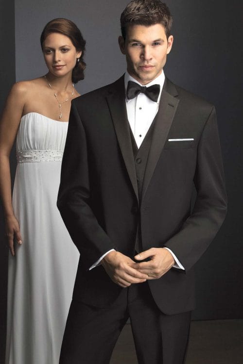 A man in an Allure Charcoal tuxedo and a woman in an Allure Charcoal dress for their wedding day.