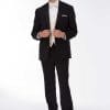 A man in a black Michael Kors Desire tuxedo rental posing for a photo.