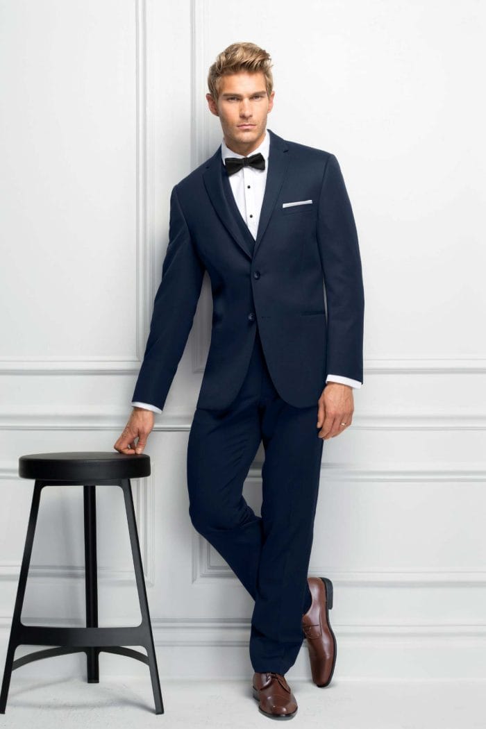 A man in an Allure Charcoal tuxedo, showcasing the elegance of suit rental.
