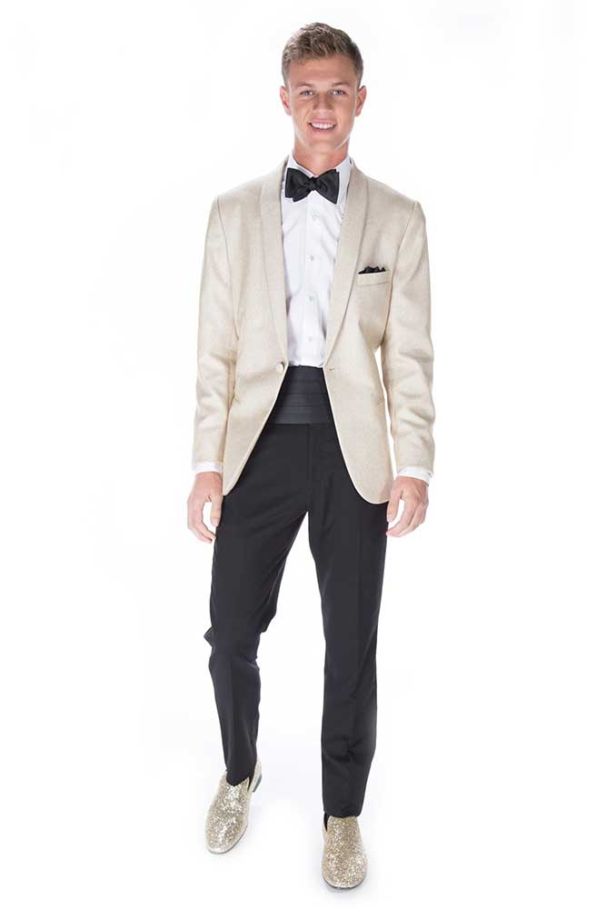 A young man in a Gold Remi tuxedo and bow tie, rented from a suit rental service.