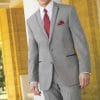 A man wearing a Heather Grey Aspen suit and red tie rented from a suit rental shop.