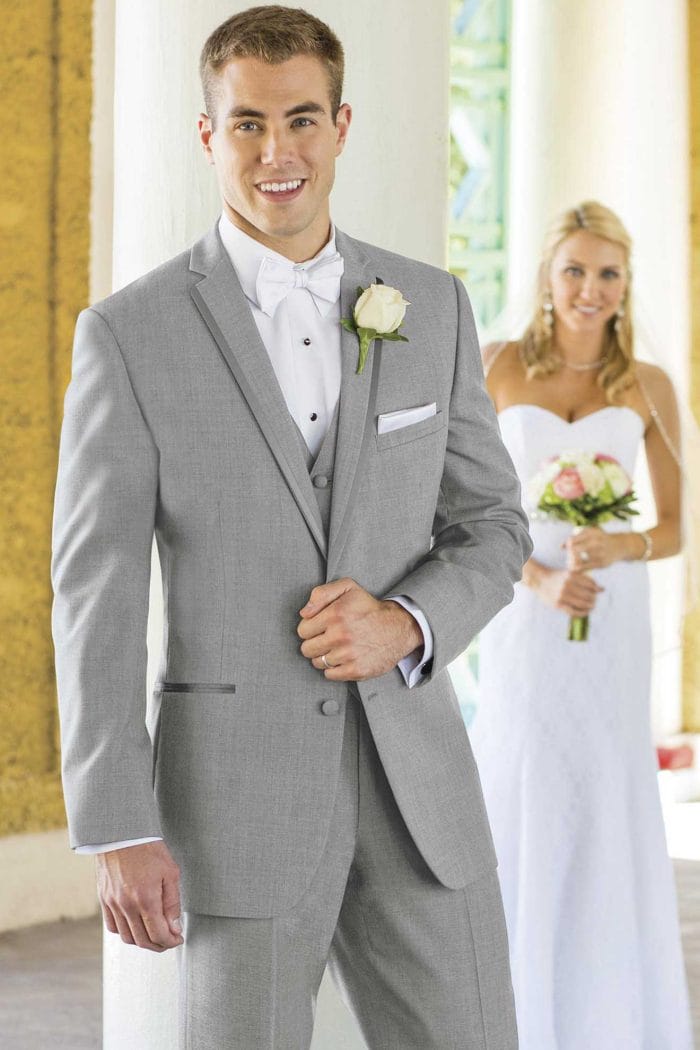 A man in a Heather Grey Aspen suit rental is standing next to a bride.