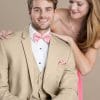 A man in a Lord West Tan Havana tuxedo and a woman in a pink dress at a suit rental shop.