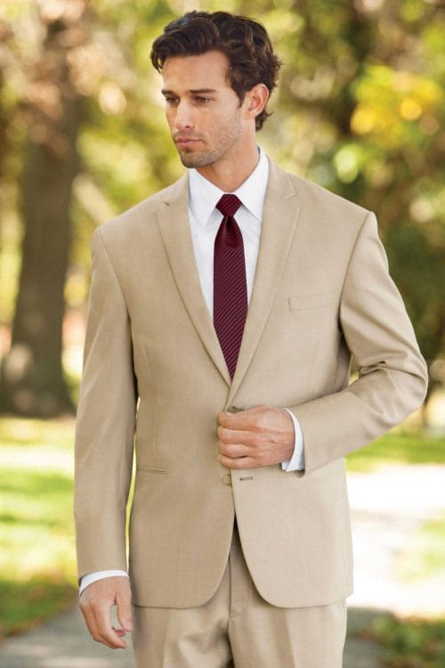 A man wearing a Lord West Tan Havana suit rental with a maroon tie.